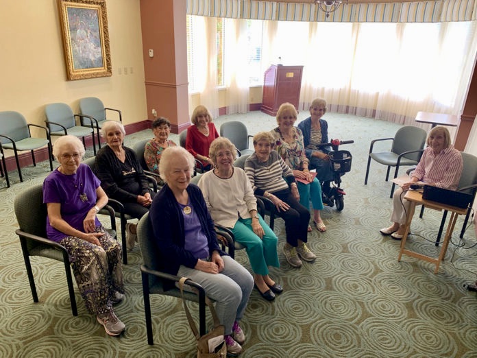 A group of residents at Abbey Delray South talking about TED talks