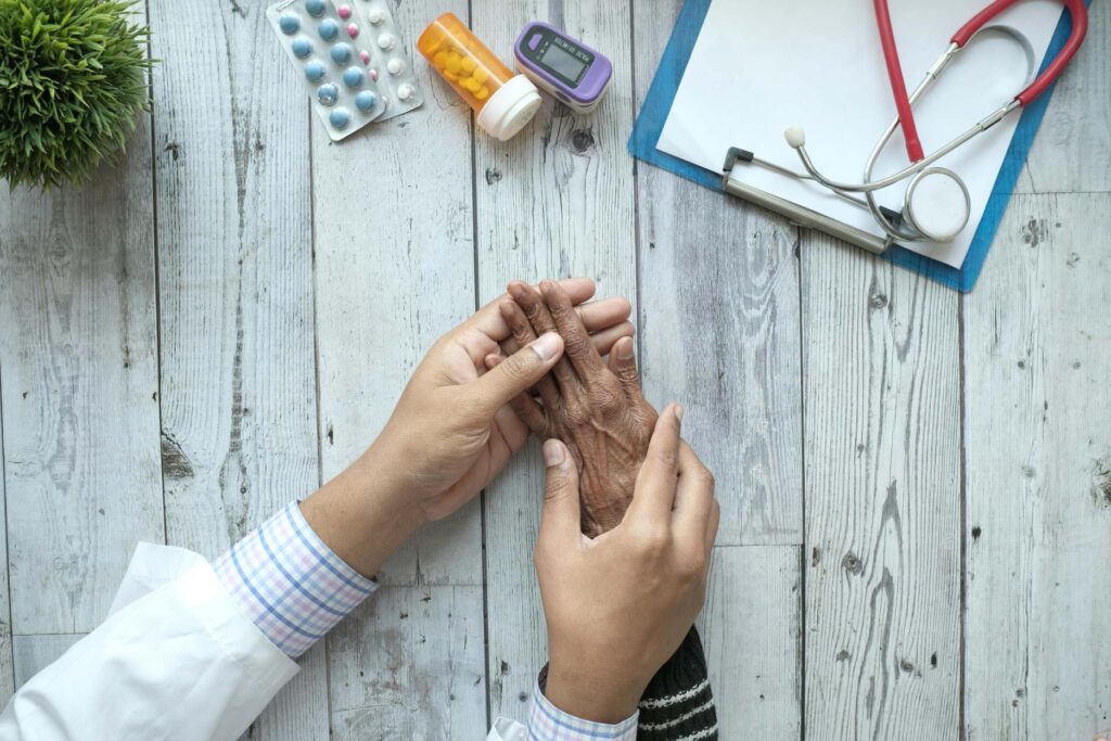 Medical Professional Holding Elderly Person's Hand