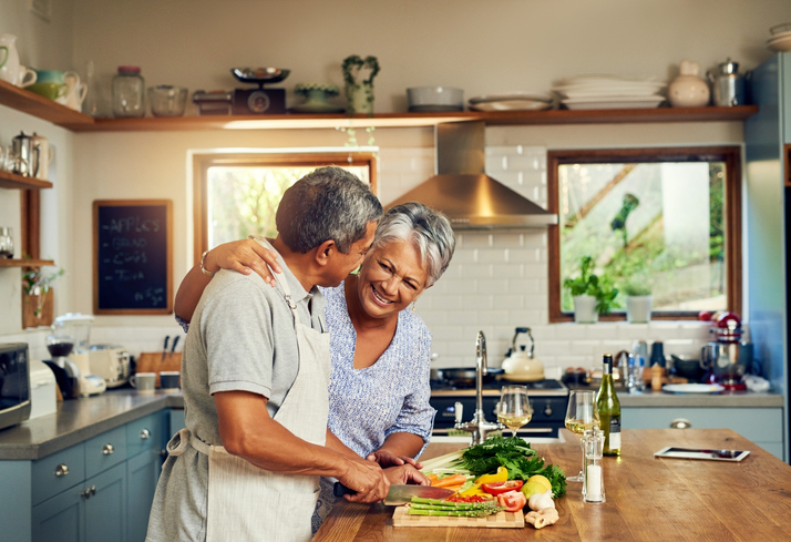 husband and wife preparing a healthy meal together in the kitchen